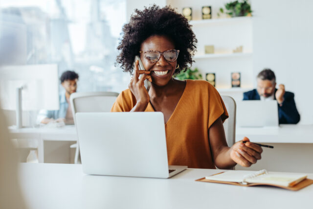 Retirement plan advisor assisting clients over the phone in a modern office, offering expert 401(k) financial planning and personalized retirement solutions.