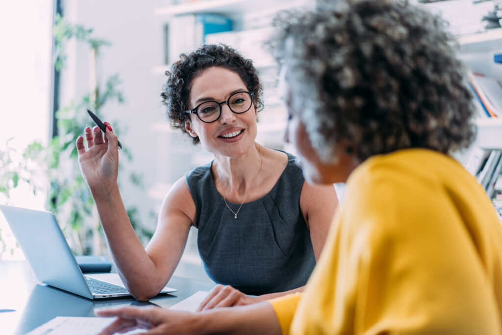 FisherSMB retirement plan advisor discussing cash balance retirement plans, including defined contribution strategies and compliance support, with a prospective client in a professional office, offering personalized financial planning and secure retirement strategies