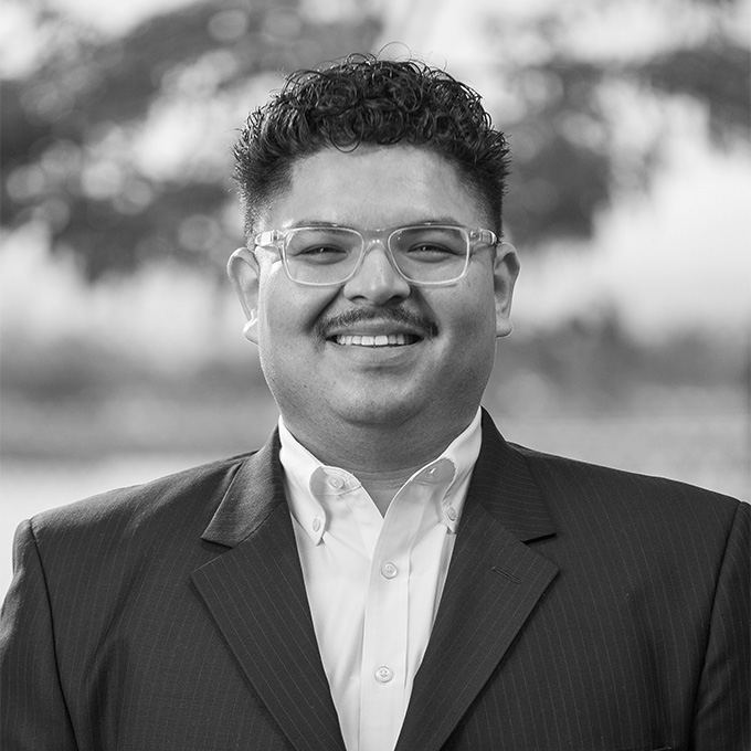 Black and white photo of man in blazer. This is Alejandro Garcia's bio.