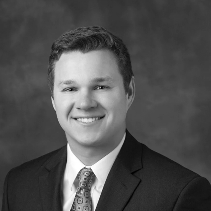 Black and white photo of man in blazer. This is Andrew Crim's bio.