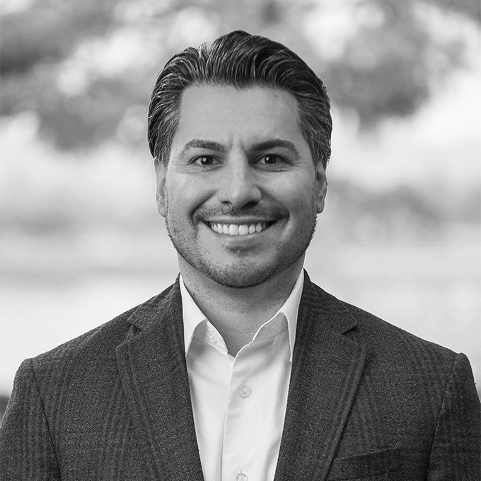 Black and white image of man in blazer. This is Armando Neri's bio.