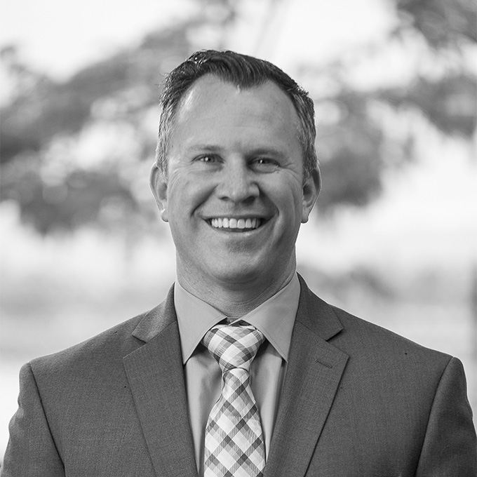 Black and white image of man in blazer. This is Brian Griffith's bio.