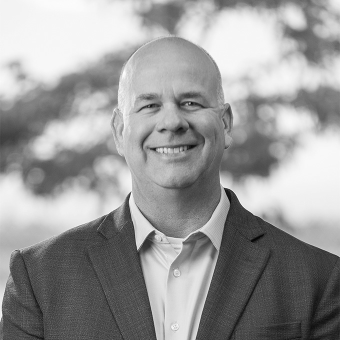 Black and white image of man in blazer. This is Bruce Simpson's bio.