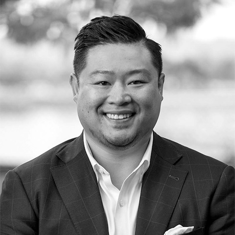 Black and White photo of Asian middle aged man wearing a blazer. This is David Bui's bio.
