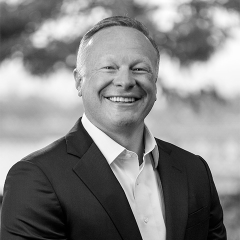 Black and White photo of white middle aged man wearing a blazer. This is Ed Johnsen's bio.