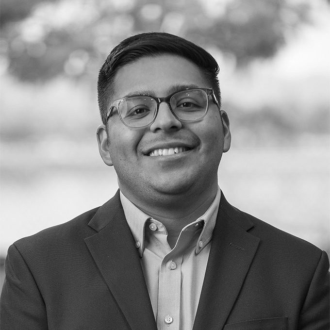 Black and white image of man in blazer. This is Edgar Gutierrez's bio.