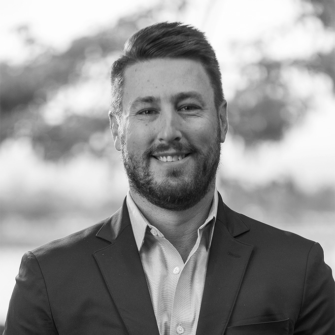 Black and white image of man in blazer. This is Hayden Lackey's bio.