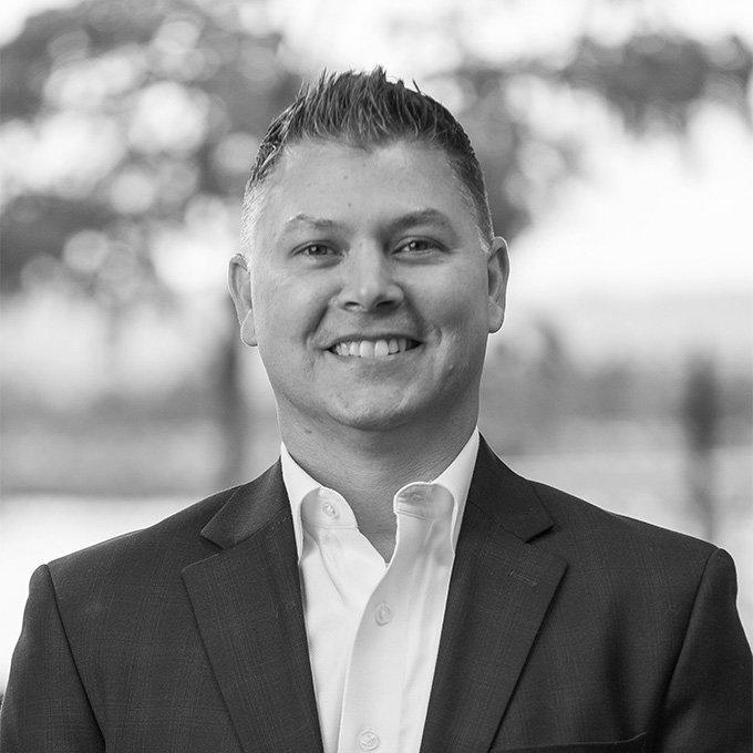 Black and white image of man in blazer. This is Jason Packham's bio.