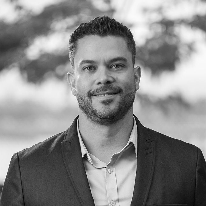 Black and white image of man in blazer. This is Micaias Rodriguez's bio.