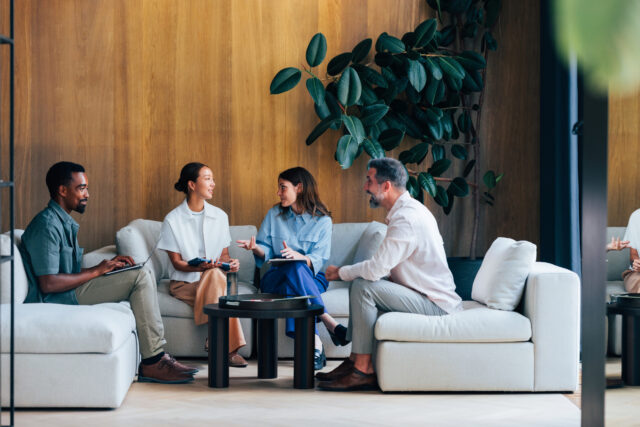 A group of employees chatting about their new pooled employer plan
